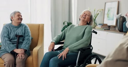 Seniors Socializing and Laughing Together Indoors