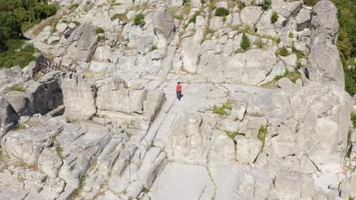 Man Visiting Ancient Thracian Town Of Perperikon In Rhodope Mountains, Bulgaria. aerial orbiting