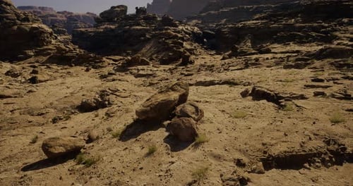 Desert Landscape with Rocky Formations and Sparse Vegetation in Daylight
