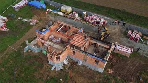 Building new house, workers and crane, aerial drone top down view of construction site