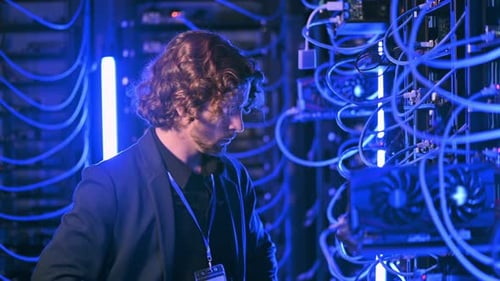 Man analysing servers in a data center