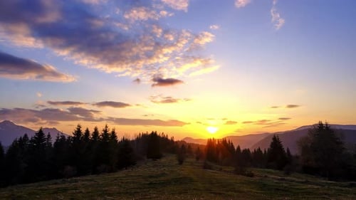 Sunset in the Forest Mountain Landscape The Clouds are Colored in Pastel Colors