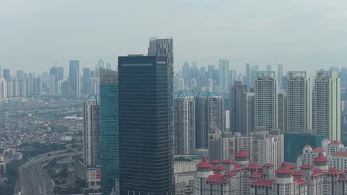 Jakarta cityscape with modern skyscrapers and urban highway traffic