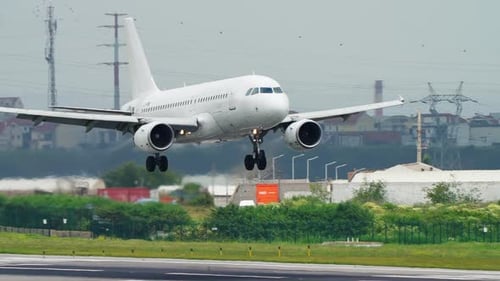 White Passenger Jet Landing on Airport Runway