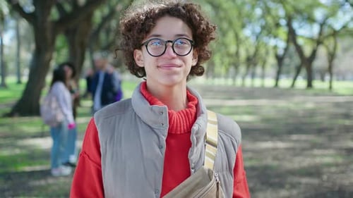 Portrait of Young Joyous Student in the Park