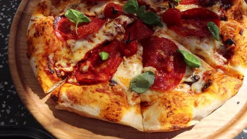 Delicious Pepperoni Pizza with Basil on Wooden Platter