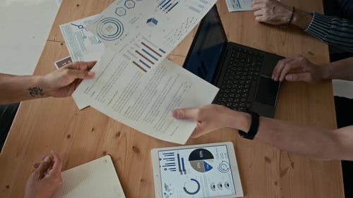 Unrecognizable People Exchanging Documents During Business Meeting in Office