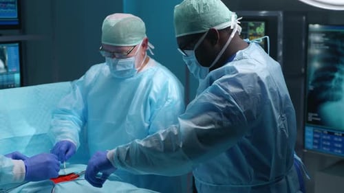 Team of Professional Medical Surgeons Performs the Surgical Operation in a Modern Hospital Doctors