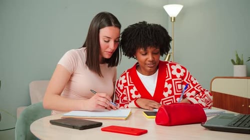 Two Young Women Studying Together at Home