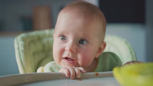 Infant Sitting in High Chair Close Up