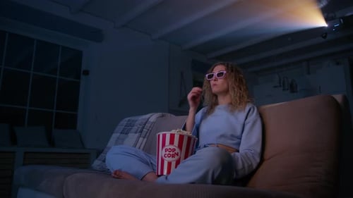 Woman Watching Movie in Dark Room at Home