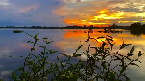The beautiful sunset over the calm waters of the lake makes for a perfect view