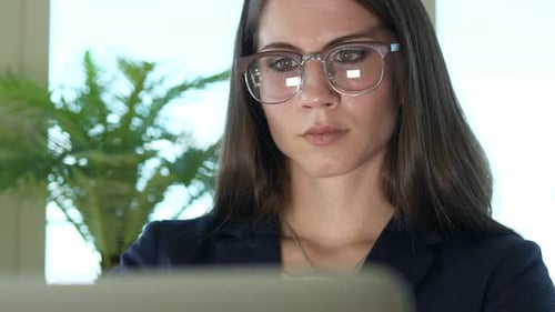Focused Woman Working at Computer in Office