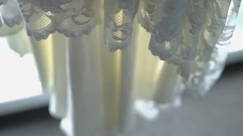 Sheer Lace Curtain Glowing in Soft Sunlight By a Bright Window