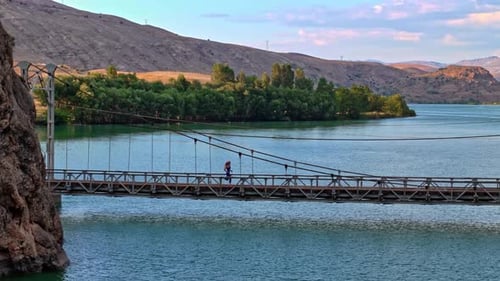 Woman Running on Bridge