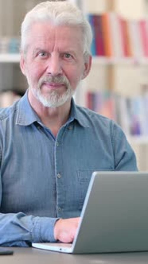 Senior Man Gives a Thumbs Up at Computer
