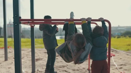 Children Playing Together on Playground Monkey Bars