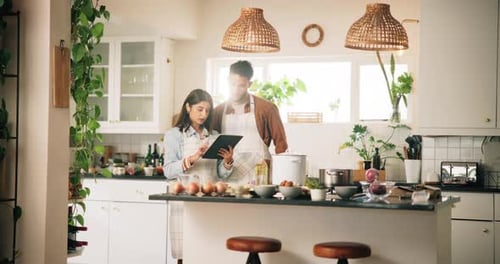 Young Couple Cooking Together in a Bright Kitchen