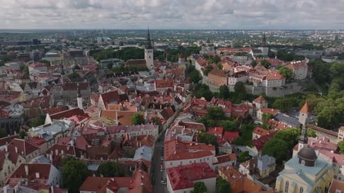 Backwards Fly Above Historic City Center Old Houses and Narrow Aisles Revealing Church with Tall