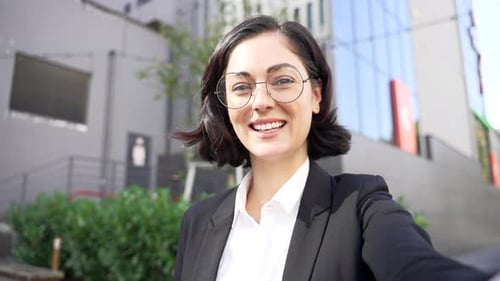 POV Webcam view Young businesswoman talking on a video call using a smartphone while standing near