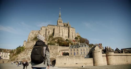 Amazing Cinematic Shot, Young Woman With Backpack Goes To Beautiful Mont Saint Michel Island