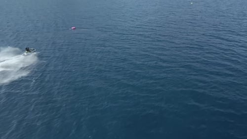 Video of a drone in motion towards jet skis doing circles in the Mediterranean