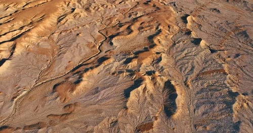 Bare arid landscape in the desert. Drone flight over the dry landscape with no vegetation.