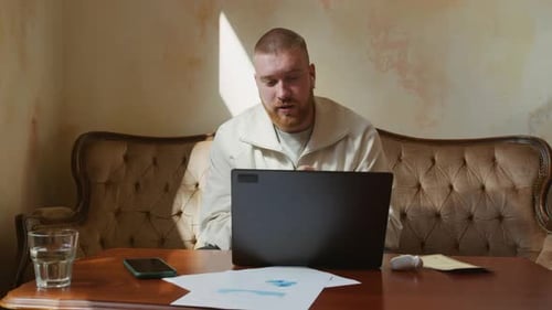 Gen Z Entrepreneur Talking on Video via Laptop in Vintage Cafe