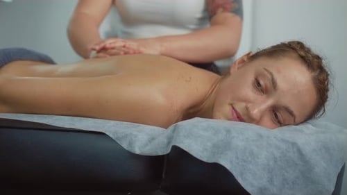 Relaxed Woman Getting Massage in Luxury Spa with Professional Massage Therapist Wellness Healing and