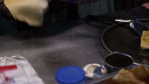 Hands stretching and folding dough for cooking