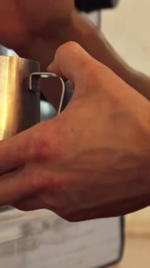 Hands Making Espresso with Chrome Machine Close Up