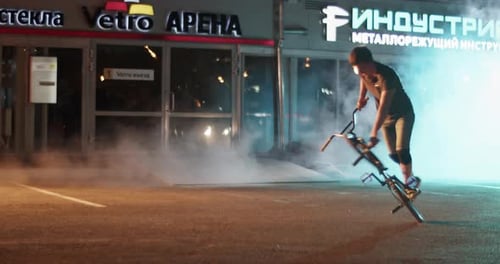 BMX Bike Tricks in City at Night