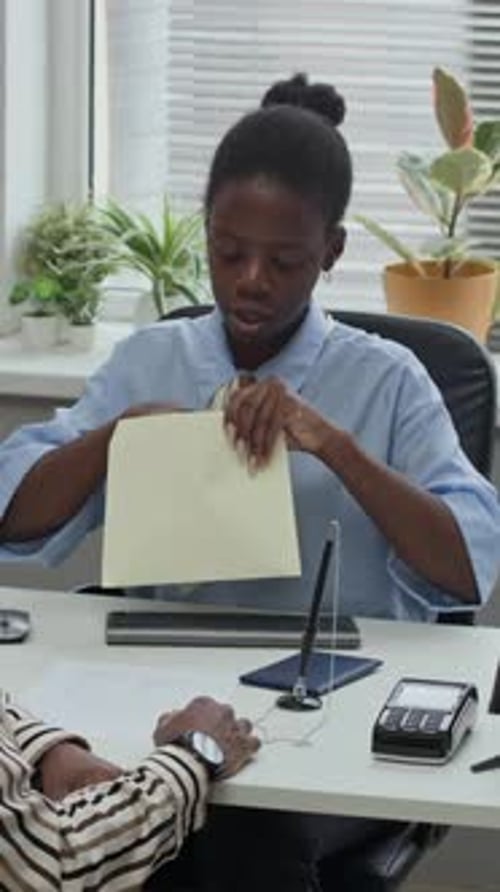 Female Employee Counting Banknotes Providing Loan to Client in Bank Office