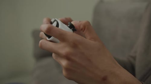 Hands Operate White Video Game Controller
