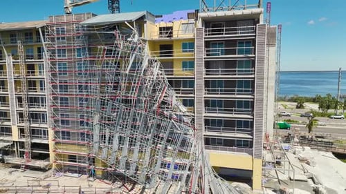 Aerial View of Ruined By Hurricane Ian Construction Scaffolding on High Apartment Building Site