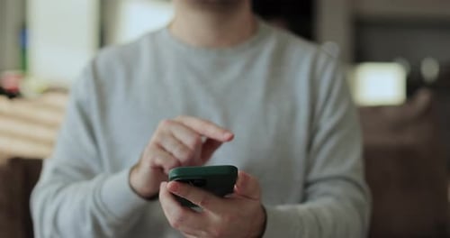 Person using cellular mobile phone indoors