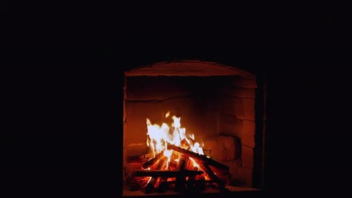Fireplace with Burning Logs at Night