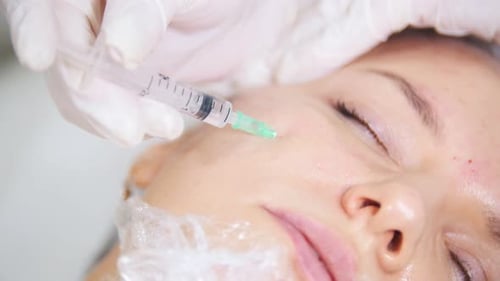 Cosmetic Procedure of Mesotherapy of the Face Making Injections in