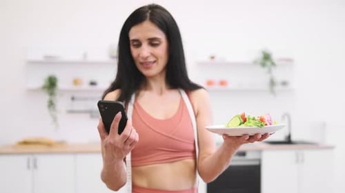 Woman Tracks Calories with Salad and Phone App