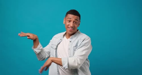 Happy Young African American Man Dancing Over Blue Studio Background