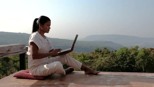 Woman Working on Laptop Outdoors in Nature