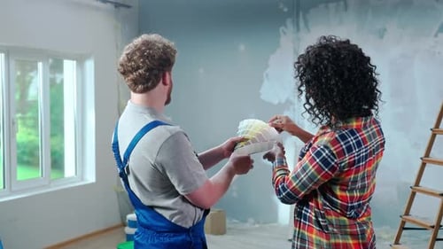 Man and Woman Discuss Paint Colors in a Home