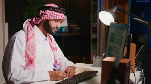 Focused Young Adult Working at Night