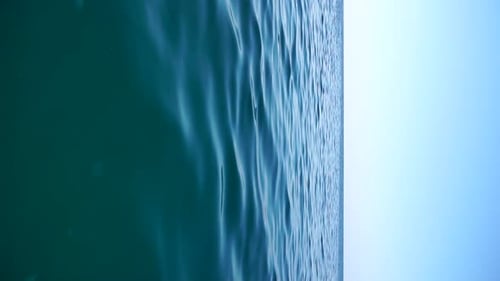 Vertical Aerial View on Sea Water Surface Camera Flies Over Clear Sea Water Sun Glare Abstract