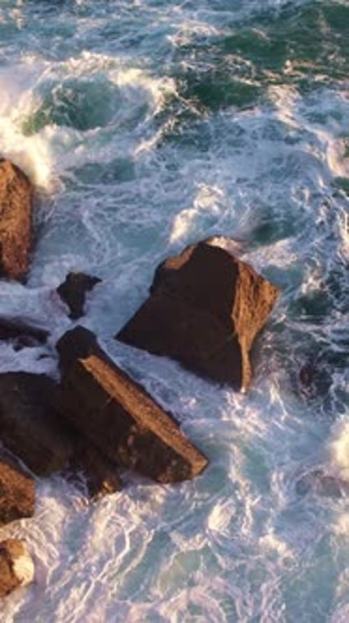 Sea Waves Wash the Stones in the Light of the