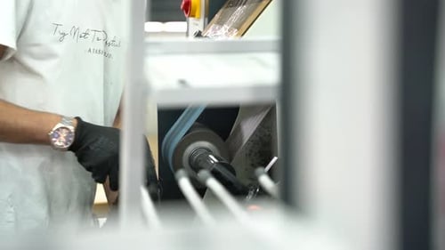 Worker Correcting Soles at Shoe Factory