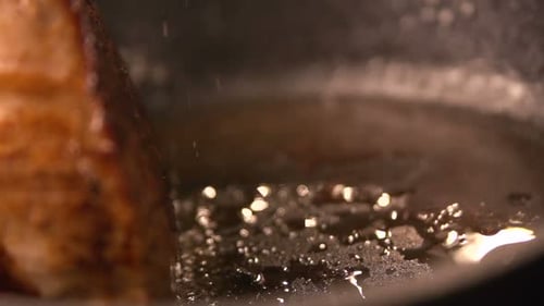 Juicy grilled filet mignon sizzling on a hot pan a gourmet meat slow motion close up