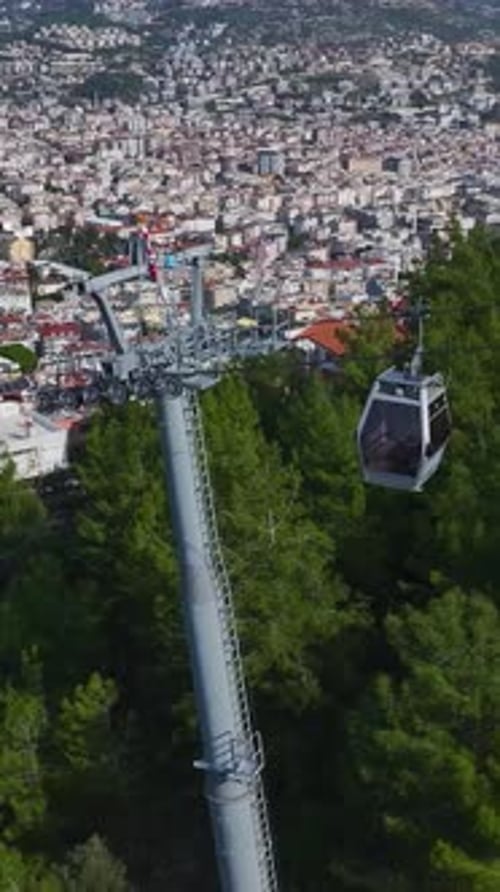 Aerial Video of a Cable Car Above a Green Landscape Offering a Stunning View of the Bright Blue
