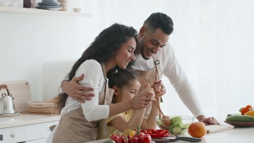 Family Cooking Together in a Bright Kitchen with Fresh Ingredients