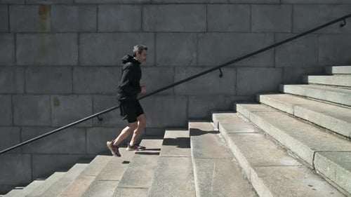 Man Running Up Stairs in Urban Environment